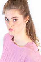 eine Frau mit vielen Sommersprossen und glänzenden Augen trägt ein aus einem Schnittmuster selbst genähtes Kleid